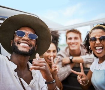 Travel, adventure and selfie with friends celebrating freedom and showing hand peace sign outdoors